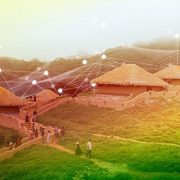 Rural village in India with traditional huts connected by a digital network overlay, representing internet connectivity and Digital India initiatives