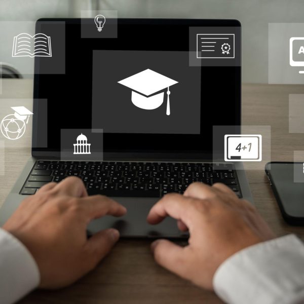 Person typing on a laptop displaying a graduation cap icon, surrounded by digital education symbols representing online learning and skill development.