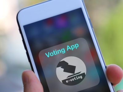 Close-up of a smartphone displaying a digital voting app interface for online e-voting and electronic election systems.