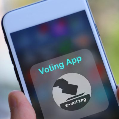Close-up of a smartphone displaying a digital voting app interface for online e-voting and electronic election systems.