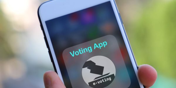 Close-up of a smartphone displaying a digital voting app interface for online e-voting and electronic election systems.