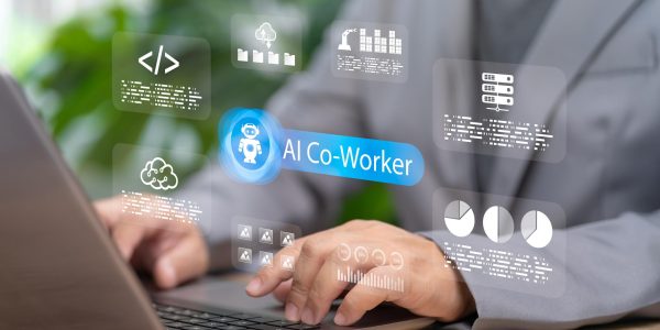 Professional using a laptop with a digital AI co-worker interface displayed on screen, featuring data analytics, cloud storage, coding, and workflow automation icons representing AI-powered workplace productivity and collaboration.